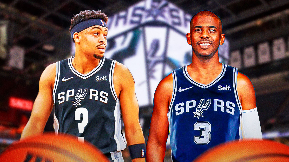 Spurs' Chris Paul smiling while holding his jersey with '3', with Keldon Johnson beside him wearing a Spurs jersey with a question mark instead of a number