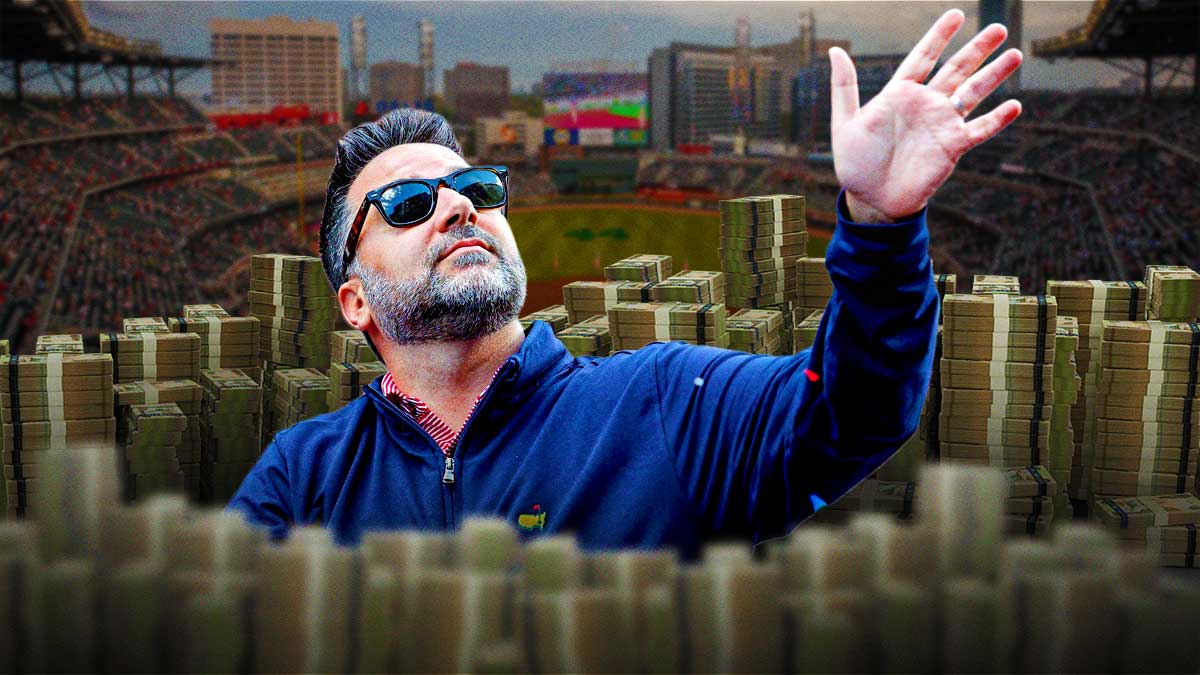Alex Anthopolous (Braves president) with a stack of money. Truist Park background (Atlanta)