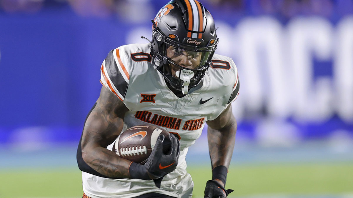 Oklahoma State Cowboys running back Ollie Gordon II (0) runs for a catch for a touchdown against the Brigham Young Cougars during the first quarter at LaVell Edwards Stadium.