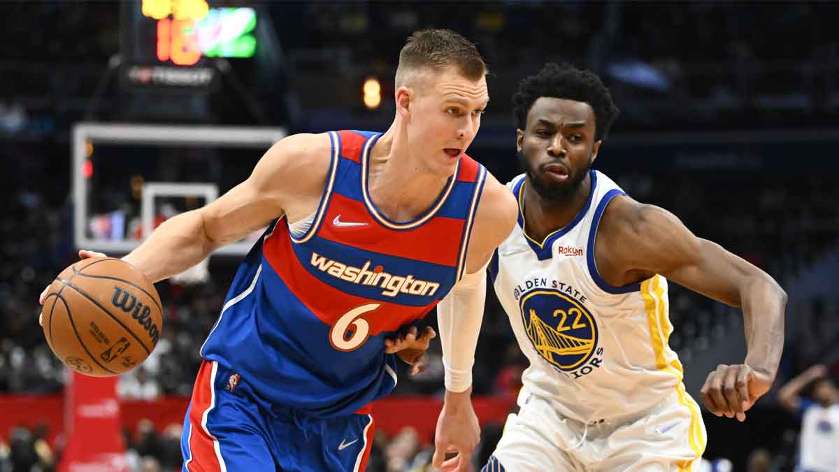 Washington Wizards center Kristaps Porzingis (6) dribbles past Golden State Warriors forward Andrew Wiggins (22) during the second half at Capital One Arena.