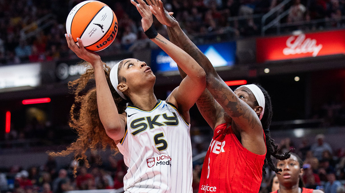 Chicago Sky forward Angel Reese (5) shoots the ball while Indiana Fever forward Natasha Howard (6) defends in the second half at Gainbridge Fieldhouse.