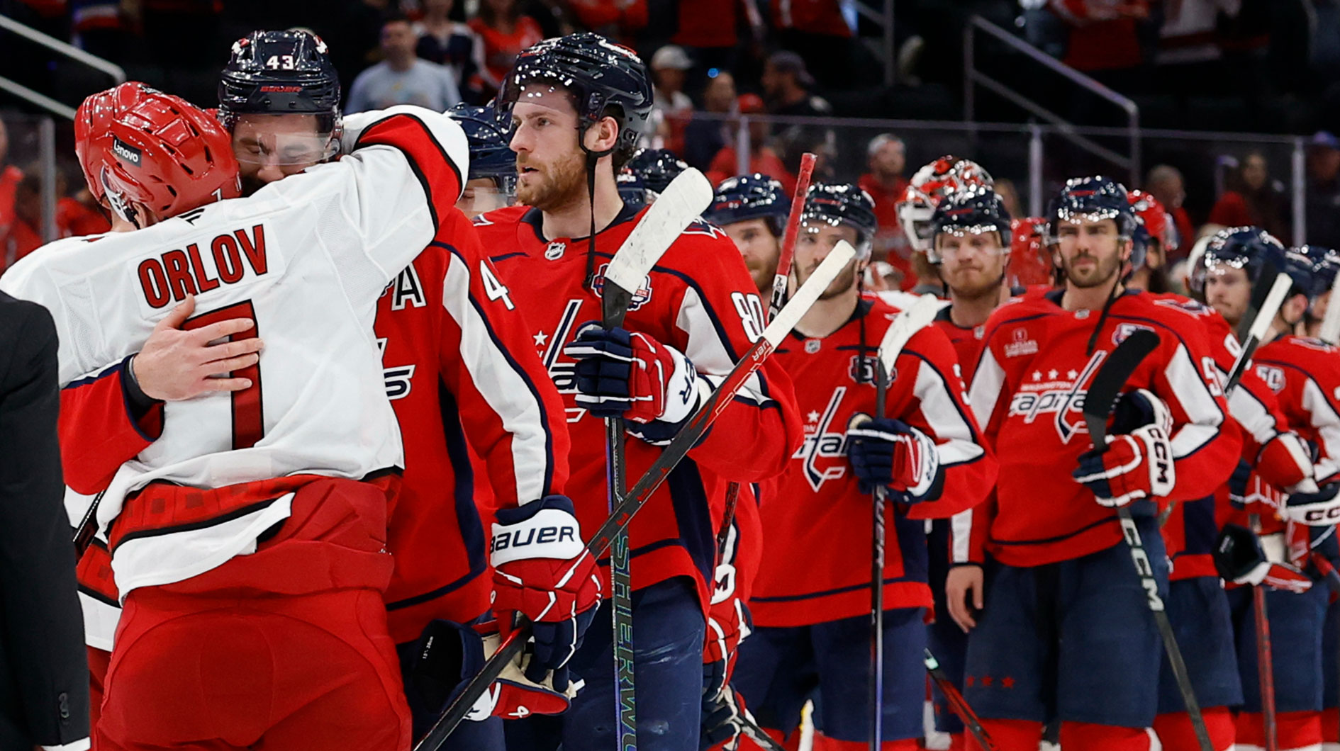 Carolina Hurricanes defenseman Dmitry Orlov (7) hugs Washington Capitals right wing Tom Wilson (43) in the handshake line after game five of the second round of the 2025 Stanley Cup Playoffs at Capital One Arena.