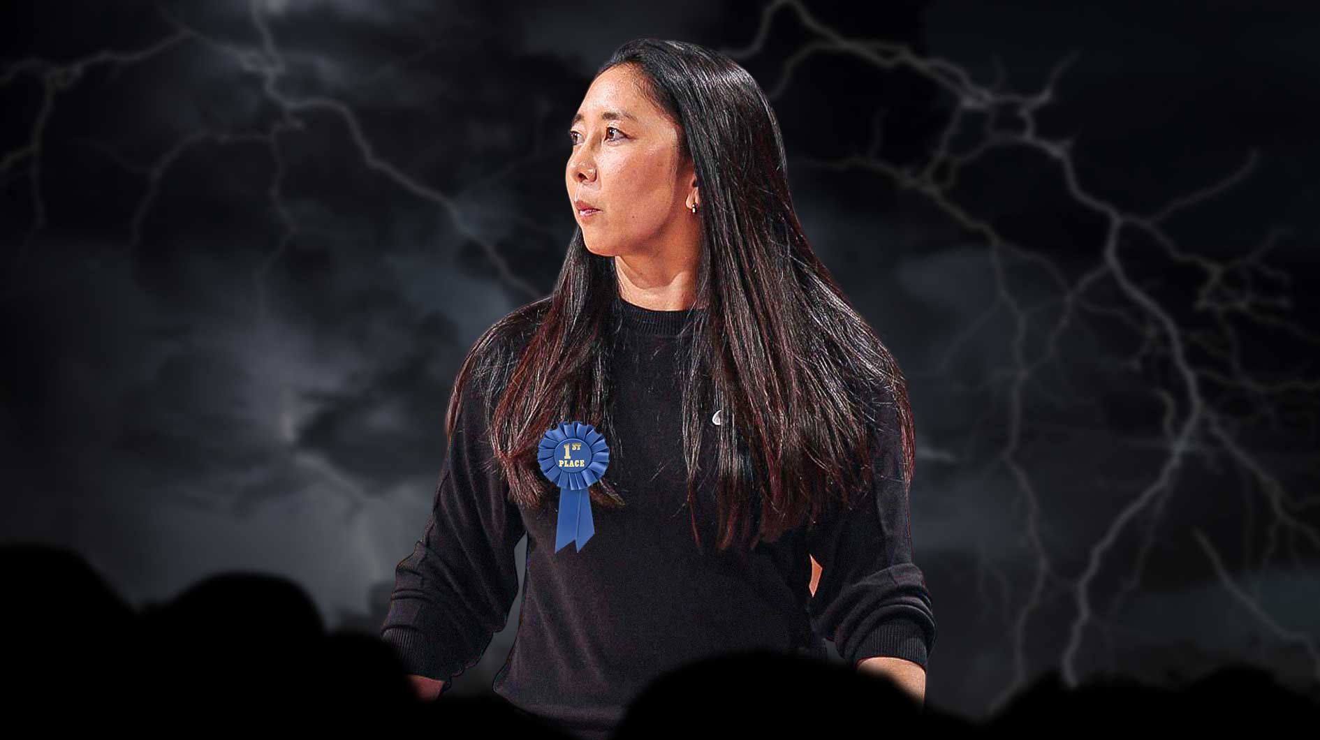 Valkyries Natalie Nakase with a first-place ribbon and a heavy rain storm around her.
