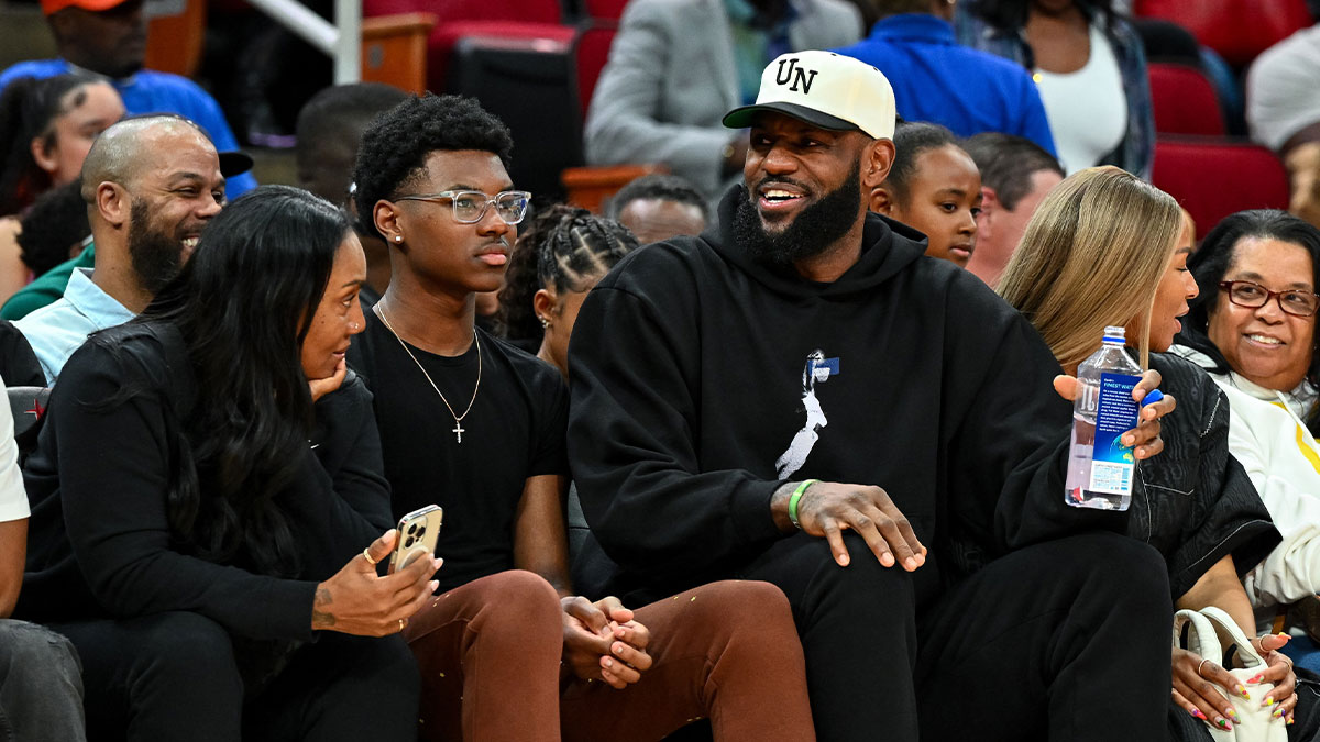 Los Angeles Lakers forward LeBron James sits with his wife Savannah James (right), son Bryce Maximus James (left) and his mother Gloria Marie James (left) court side of the between the McDonald's All American East and the McDonald's All American West at Toyota Center.