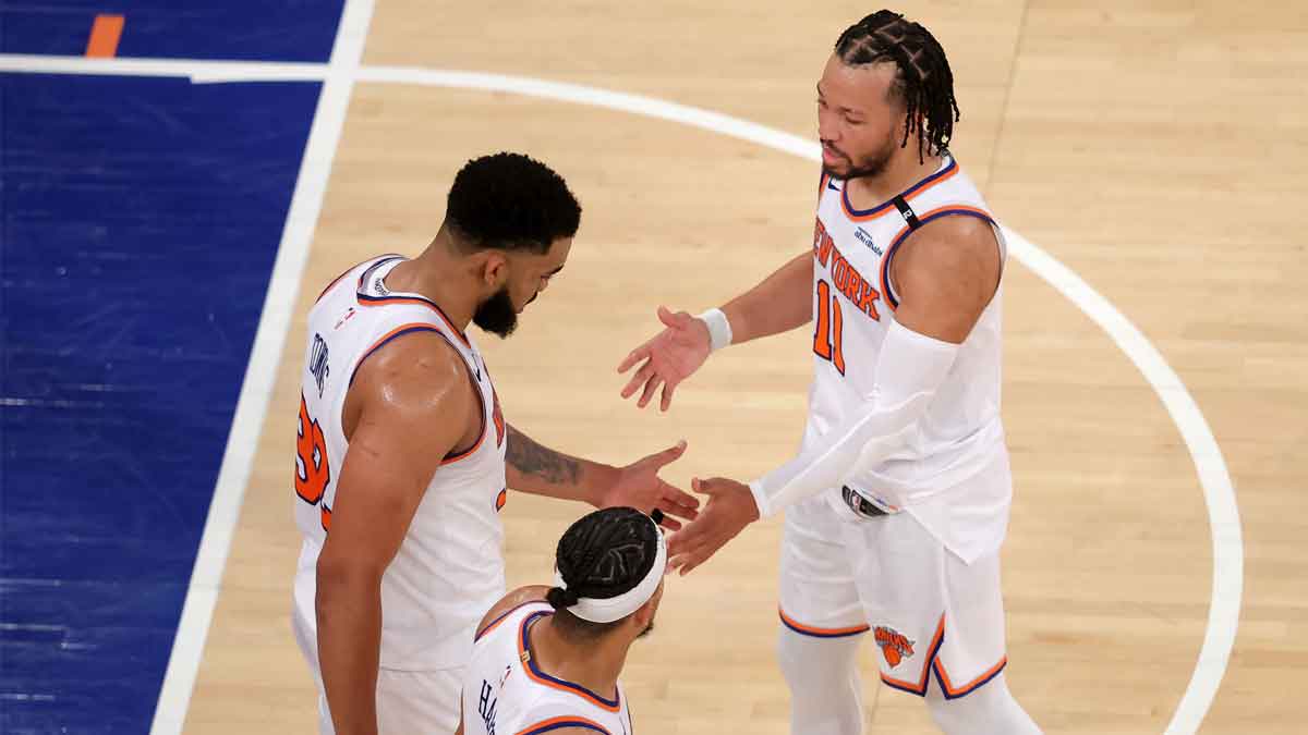 New York Knicks guard Jalen Brunson (11) and center Karl-Anthony Towns (32) and guard Josh Hart (3) react in the fourth quarter against the Indiana Pacers during game five of the eastern conference finals for the 2025 NBA Playoffs at Madison Square Garden.