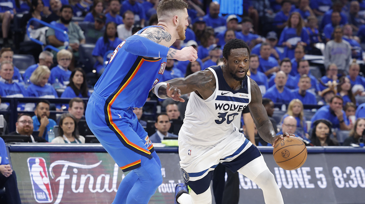 Minnesota Timberwolves forward Julius Randle (30) drives against Oklahoma City Thunder center Isaiah Hartenstein (55) in the third quarter during game two of the western conference finals for the 2025 NBA Playoffs at Paycom Center.