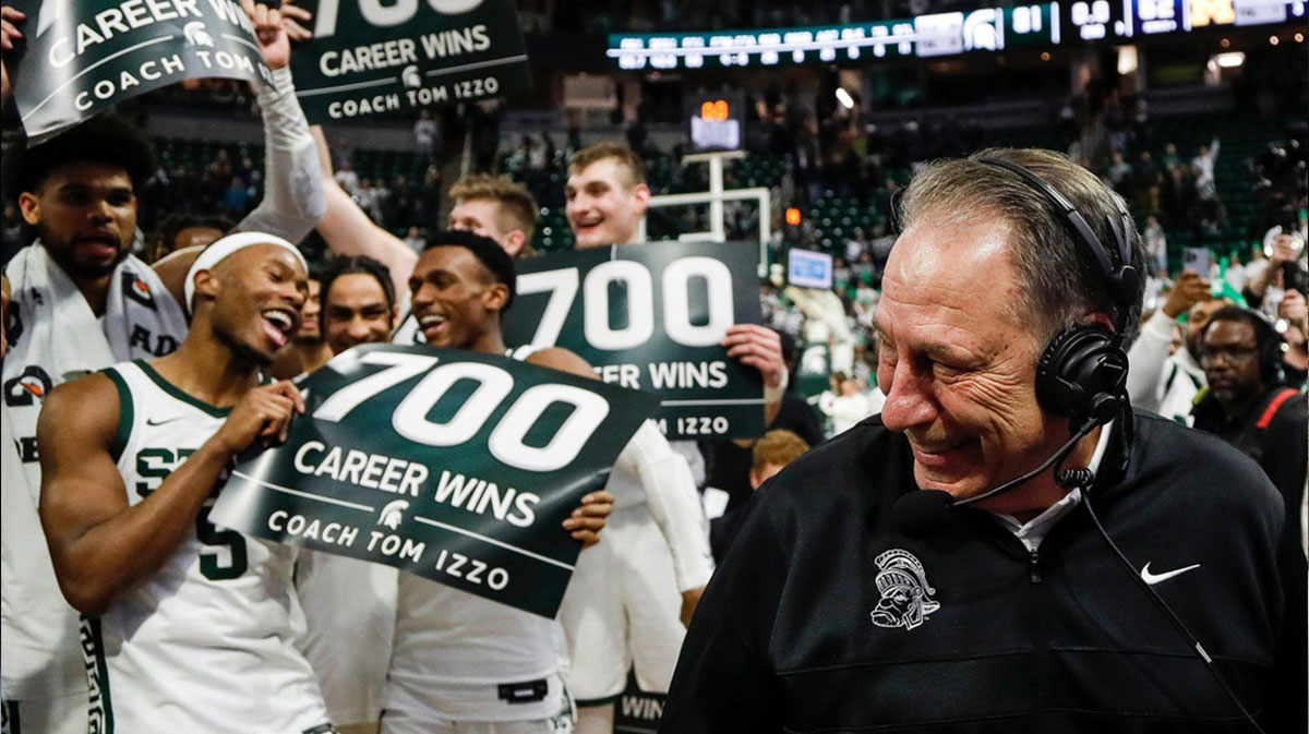 Michigan State players celebrate head coach Tom Izzo's 700 career win as head coach Tom Izzo is being interviewed after 81-62 win over Michigan at Breslin Center in East Lansing.