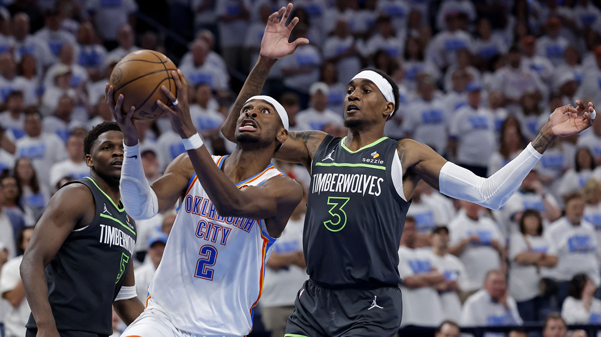Oklahoma City Thunder guard Shai Gilgeous-Alexander (2) drives against Minnesota Timberwolves forward Jaden McDaniels (3) in the fourth quarter during game one of the western conference finals for the 2025 NBA Playoffs at Paycom Center.