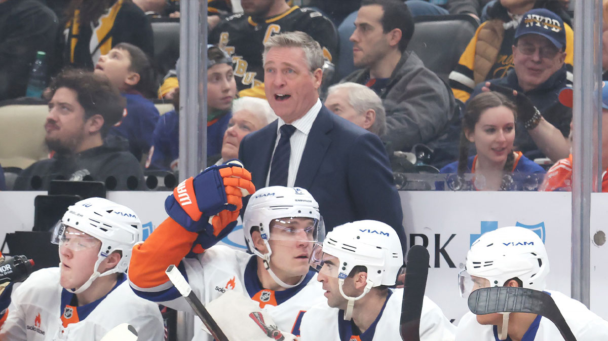 New York Islanders head coach Patrick Roy (rear) reacts on the bench against the Pittsburgh Penguins during the third period at PPG Paints Arena.