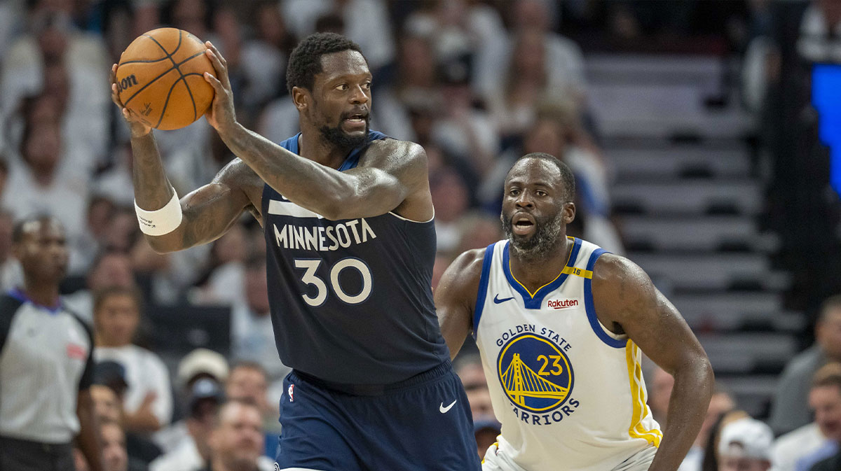 Minnesota Timberwolves forward Julius Randle (30) holds the ball as Golden State Warriors forward Draymond Green (23) plays defense in the second half during game five of the second round for the 2025 NBA Playoffs at Target Center.