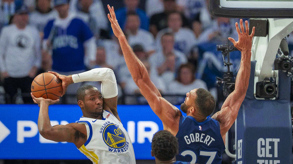 Warriors forward Jonathan Kuminga (00) looks to pass the ball over Minnesota Timberwolves center Rudy Gobert (27) in the first half during game two of the second round for the 2025 NBA Playoffs at Target Center