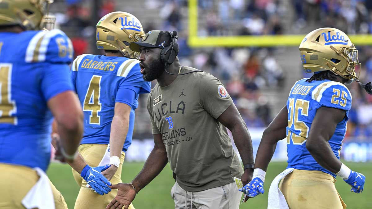 UCLA Bruins head coach DeShaun Foster greets his players after a Bruins touchdown against the Fresno State Bulldogs in the third quarter at Rose Bowl.