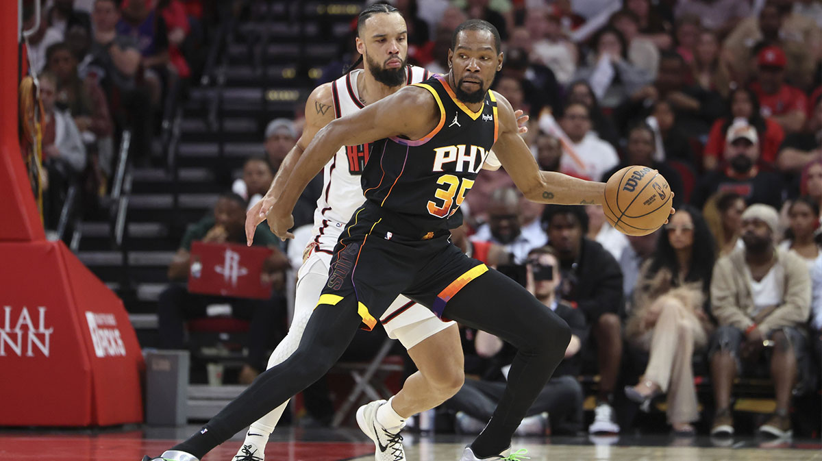 Phoenix Suns forward Kevin Durant (35) controls the ball as Houston Rockets forward Dillon Brooks (9) defends during the third quarter at Toyota Center.