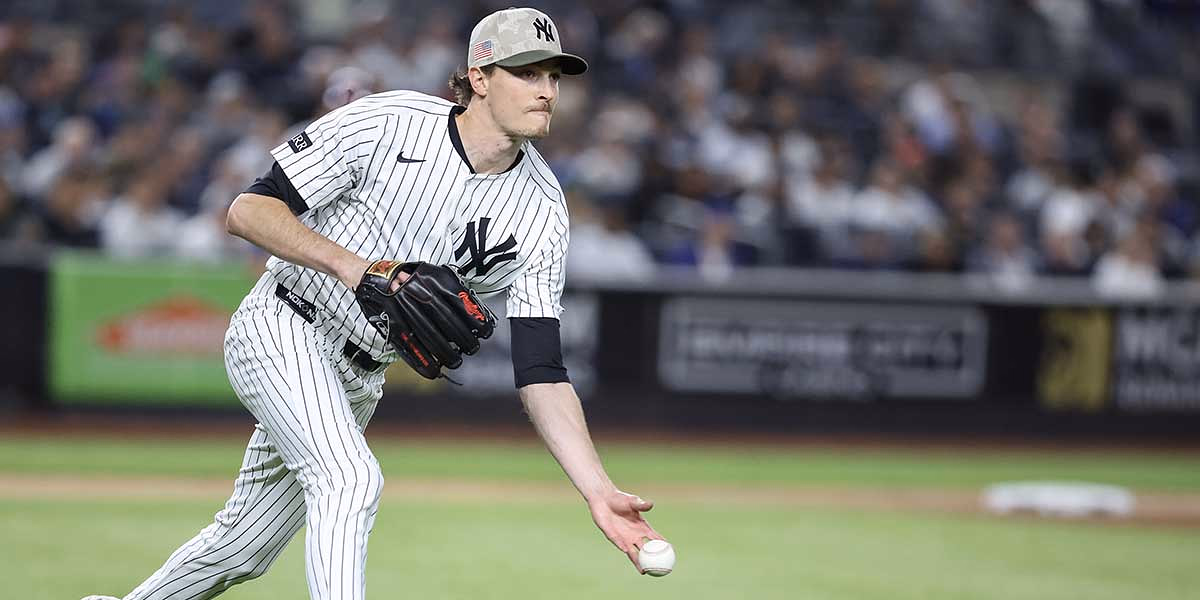 New York Yankees starting pitcher Max Fried (54) throws a runner out at first base in the fifth inning against the New York Mets.