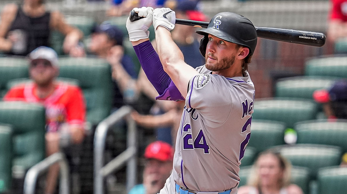 Colorado Rockies third baseman Ryan McMahon (24) hits a home run against the Atlanta Braves during the seventh inning at Truist Park.