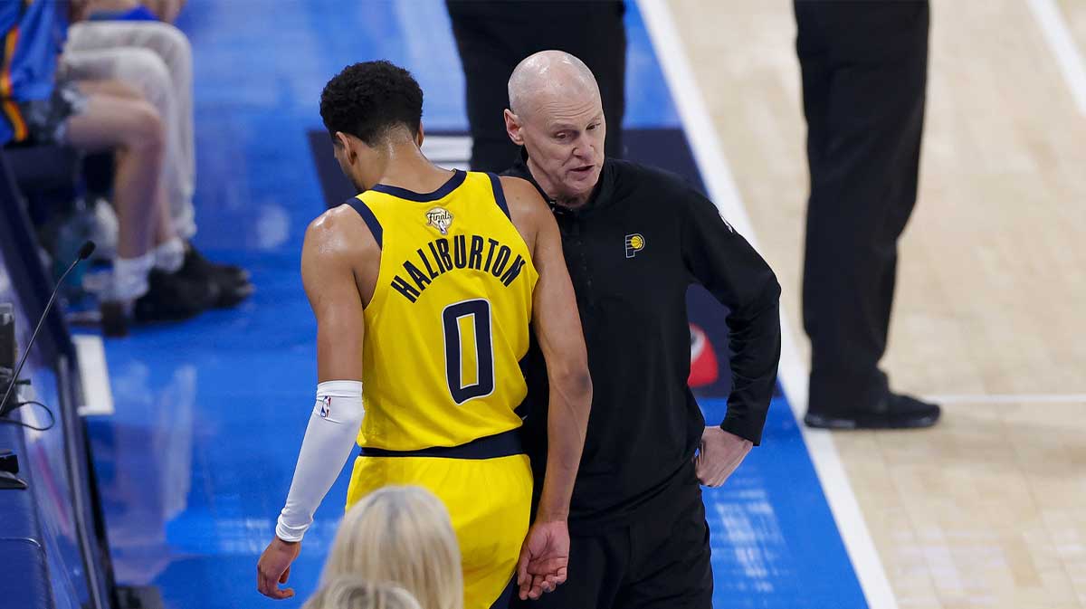 Indiana Pacers guard Tyrese Haliburton (0) comes off the floor past head coach Rick Carlisle in the first quarter against the Oklahoma City Thunder during game five of the 2025 NBA Finals at Paycom Center.